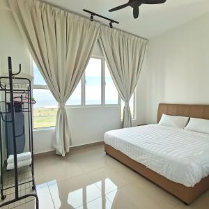 a bedroom with a bed and a large window at Amber Cove Seaview I MUJI 2BR I Game Room I 3-9pax in Malacca +71 photos