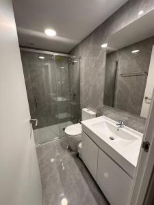 a bathroom with a toilet and a shower and a sink at Pereira Azuara in Póvoa de Varzim