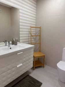 a bathroom with a sink and a toilet at Pereira Azuara in Póvoa de Varzim
