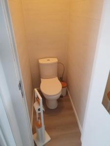 a bathroom with a toilet in a small room at Douce Mathilde in Aywaille