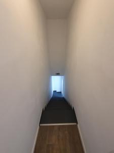 a hallway with a light at the end of a room at Douce Mathilde in Aywaille