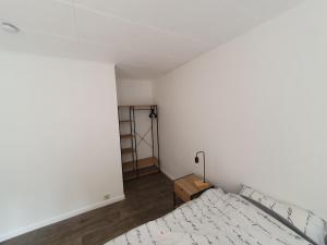 a bedroom with a bed and a wooden floor at Douce Mathilde in Aywaille