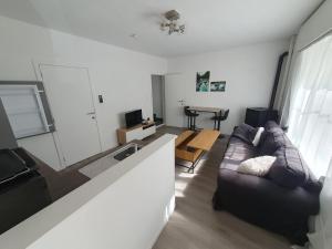 a living room with a couch and a table at Douce Mathilde in Aywaille