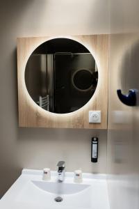 a bathroom with a sink and a mirror at Ty Ys Hôtel in Audierne
