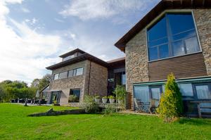 a large brick house with a green yard at La Casona de Abamia in Corao