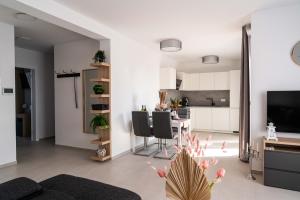 a living room with a table and a kitchen at Villa Full Moon Luxury Apartments Novalja in Novalja +16 photos