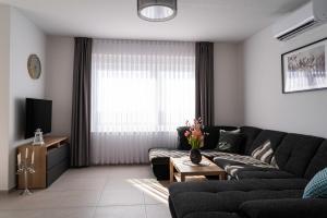 a living room with a couch and a tv at Villa Full Moon Luxury Apartments Novalja in Novalja