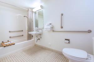a white bathroom with a toilet and a sink at Motel 6-Phoenix, AZ - Airport - 24th Street in Phoenix