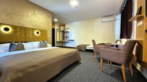 A bed or beds in a room at Penzion Nevada