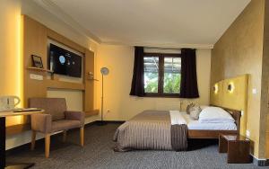 A bed or beds in a room at Penzion Nevada