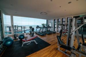 a gym with several treadmills and machines in a building at Umi Studio Imperium Residence in Telok Baru