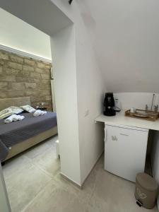 a small bedroom with a bed and a counter at Casa Chiara in Isola delle Femmine +4 photos