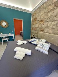 a room with a bed with white pillows on it at Casa Chiara in Isola delle Femmine