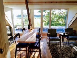 a dining room with a table and chairs and a large window at The Grutto, private apartment 25 min from city center in Amsterdam +18 photos