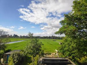 a field with a truck in the middle of it at The Grutto, private apartment 25 min from city center in Amsterdam