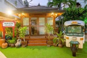 a small house with a scooter parked in front of it at Hua Hin Golf Villa in Hua Hin
