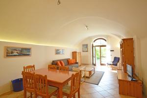a living room with a table and a couch at Agriturismo La Filanda in Manerba del Garda