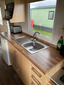 a kitchen with a sink and a window at The Dean's on the Edge in Heysham