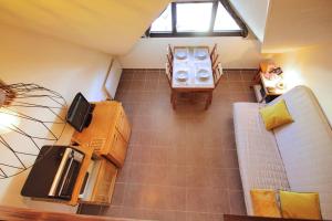 an overhead view of a living room with a couch at Studio duplex au pied des pistes in Laveissière