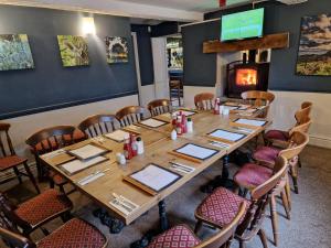 a dining room with a table and chairs and a fireplace at The Lord Nelson Inn B&B in Langho