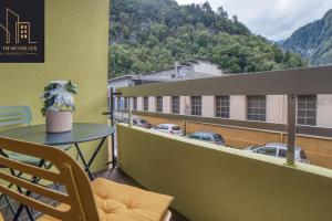 a balcony with a table and a view of a building at Appartement Pastel in Cluses