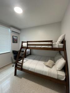 a bedroom with two bunk beds in a room at 3-Bedroom House in Quebradillas in Quebradillas