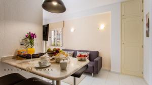 a living room with a table with fruit on it at GREICE HOMES 1 BEDROOM APARTMENT CENTRE OF VILAMOURA in Vilamoura