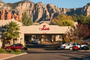 a parking lot with cars parked in front of a mountain at Arabella Hotel Sedona in Sedona