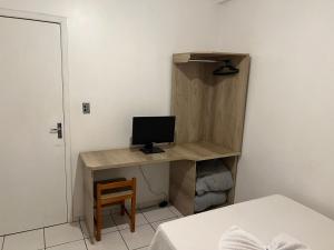 a room with a desk with a computer on it at Hotel Mello in Cascavel