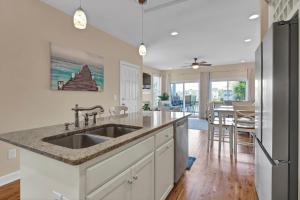 a kitchen with a sink and a counter top at Pelican Pleasure by Sea Scape Properties in Carolina Beach