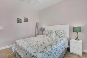 a bedroom with a large bed with two lamps at Pelican Pleasure by Sea Scape Properties in Carolina Beach