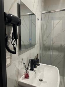 a bathroom with a sink with a phone on it at Golden Palm B&B in Bari