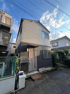 a house with its door open on a street at Nerima house in Tokyo