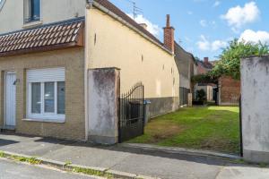 ein Haus mit einem Seitentor in der Unterkunft 'Maison Baptiste' la campagne en ville in Annoeullin