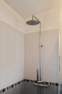 a bathroom with a shower with a glass door at Maison charmante vue mer - Erbalunga in Erbalunga