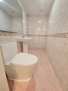 a bathroom with a toilet and a sink at Gurum Stay in Suwon