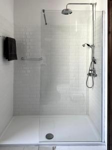 a shower with a glass door in a bathroom at Palazzo De Michele in Raiano