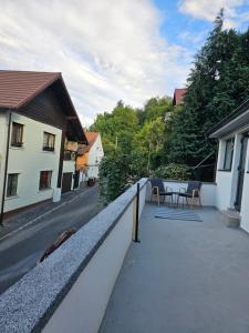 a balcony of a house with a table and chairs at Terrace Green Hill House in Braşov