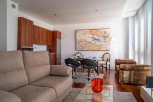 a living room with a couch and a table at Apartamentos Libertad 24 in Madrid