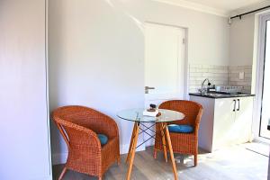 a small kitchen with a table and two chairs at The Oak Suite in Cape Town