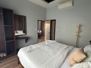a bedroom with a white bed with a towel on it at Luxury Private Pool Villa- Ao Nang Krabi in Ao Nam Mao