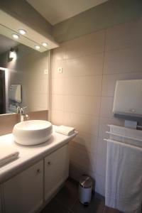a bathroom with a sink and a mirror at La rode in Compreignac