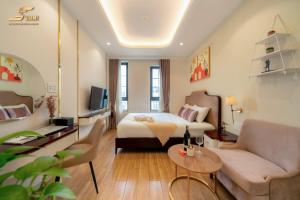 a hotel room with a bed and a couch at Simmi 6 Hotel & Apartment in Ho Chi Minh City +135 photos