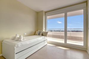 a bedroom with a white bed and a large window at Luxury Penthouse with Panoramic Sea Views in Canet de Berenguer +33 photos