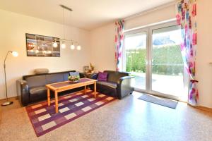 a living room with two couches and a table at Lee in Zingst