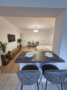 a kitchen and living room with a table and chairs at Terrace Green Hill House in Braşov