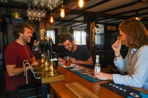 以撒港The Cornish Arms Inn的一群人坐在酒吧里 更多16张照片