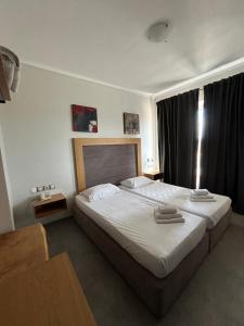 Ένα ή περισσότερα κρεβάτια σε δωμάτιο στο Perea Hotel 