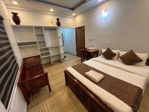 a bedroom with a large bed in a room at Confident Residency in Guruvāyūr