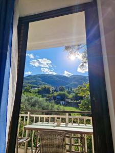 a window view of the mountains from the porch of a house at Villa ΝOSTALGΙΑ in Kokkino Nero +5 photos